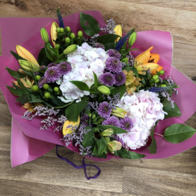 Hidden Treasure - An outstanding hand tied bouquet with a cascade of colour and a treasure chest overflowing with the beautiful flowers.